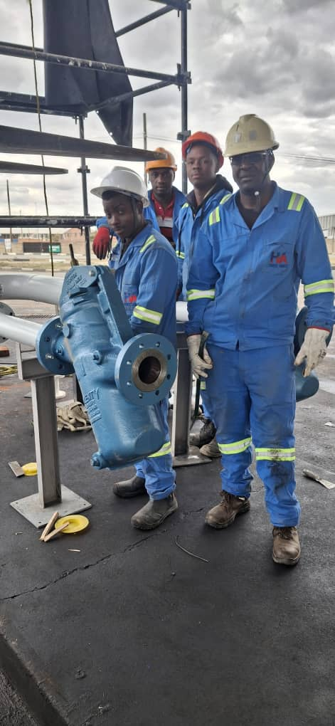 Industrial engineering and installation: team at site with PPE